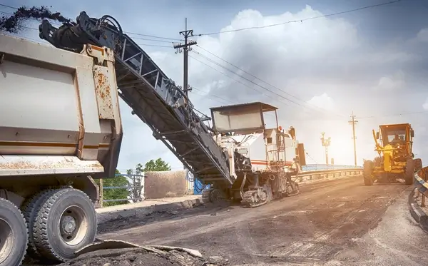 Heavy-duty milling machine removing old asphalt