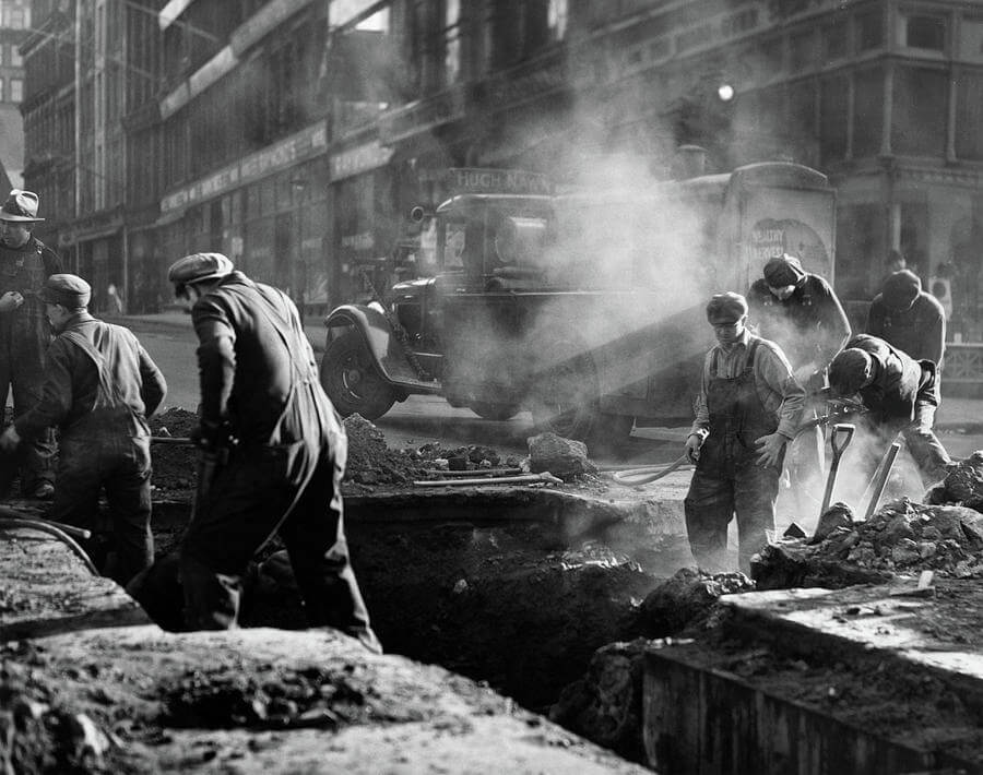 Vintage black and white photo of early road construction work.