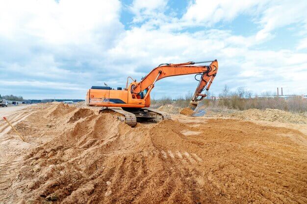 Excavator digging a trench on a new construction site
