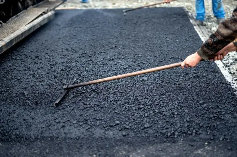Asphalt paver laying down a new layer of blacktop