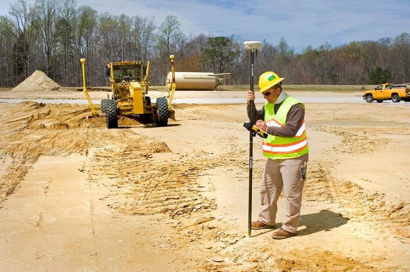 GPS-guided motor grader on a construction site